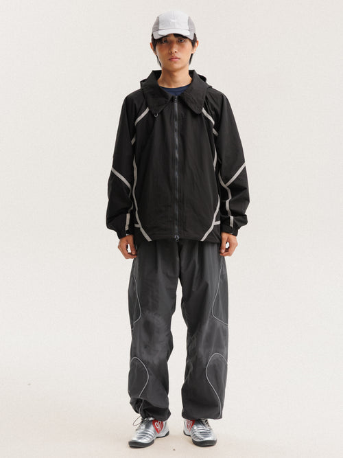 Black jacket — front view with the zip closed and curved sleeve panels visible