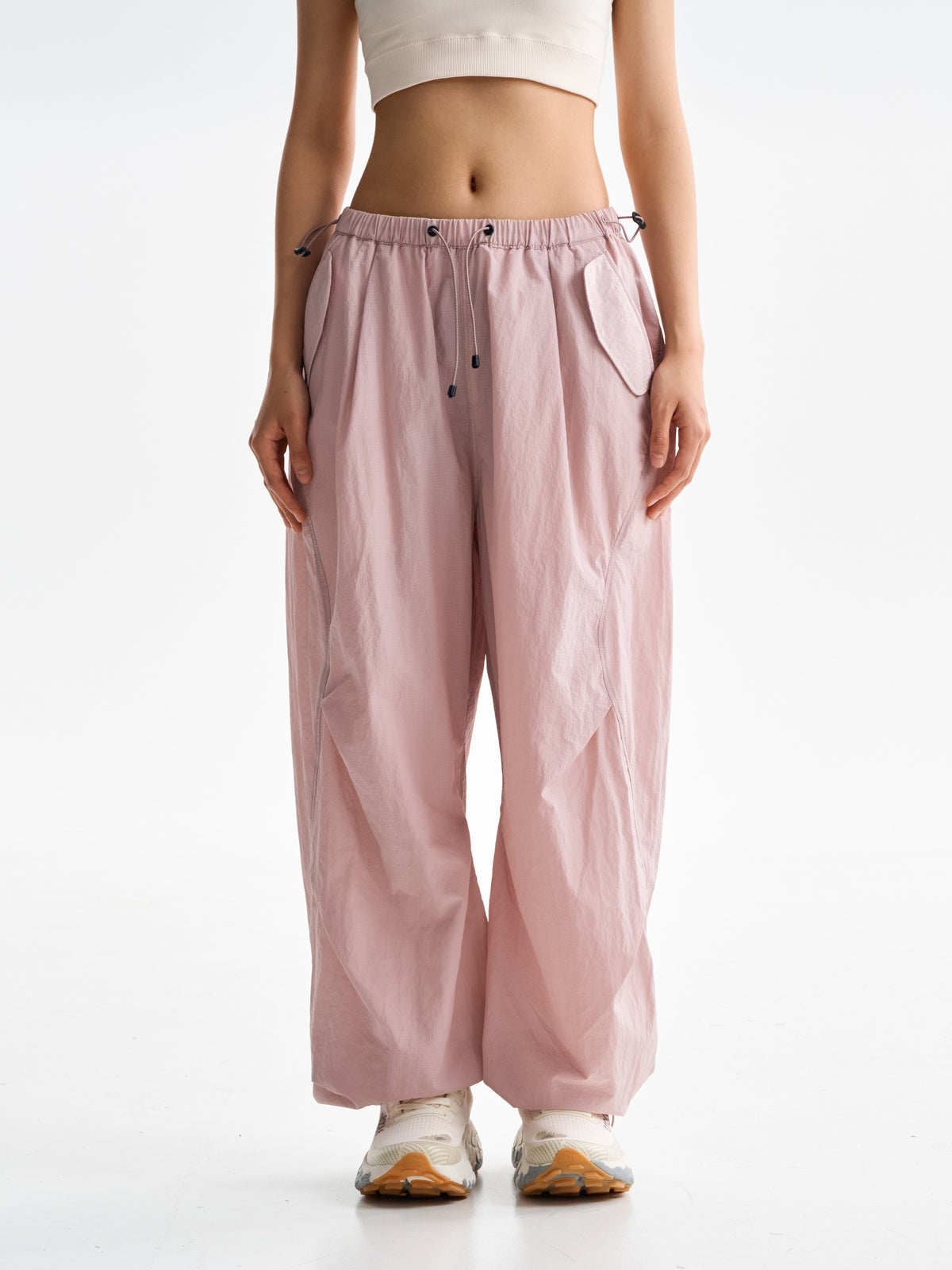 Pink hiking pants — front view showing the drawcord waist and loose legs