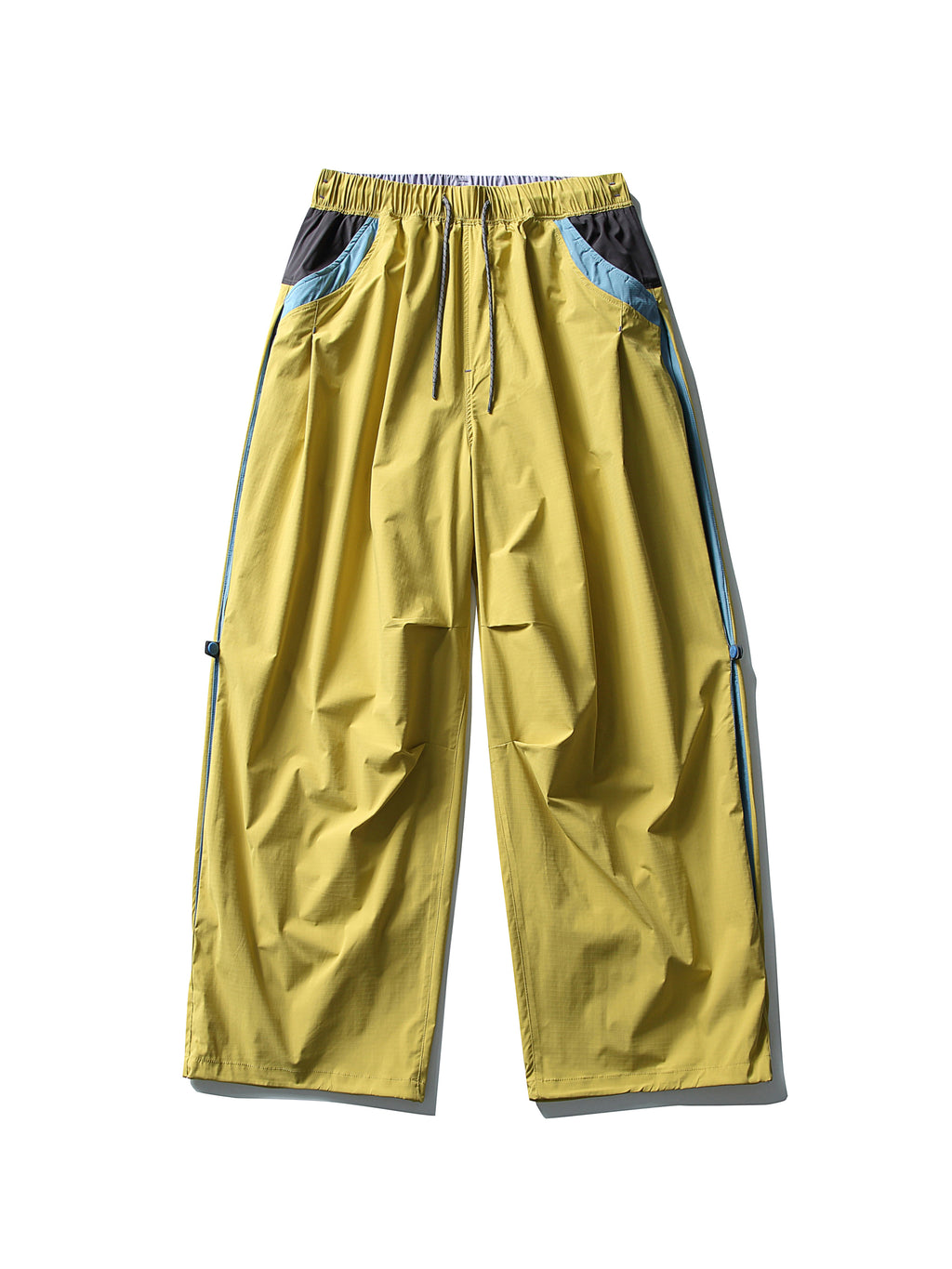 Yellow hiking pants — flat front view showing blue side panels and open hems