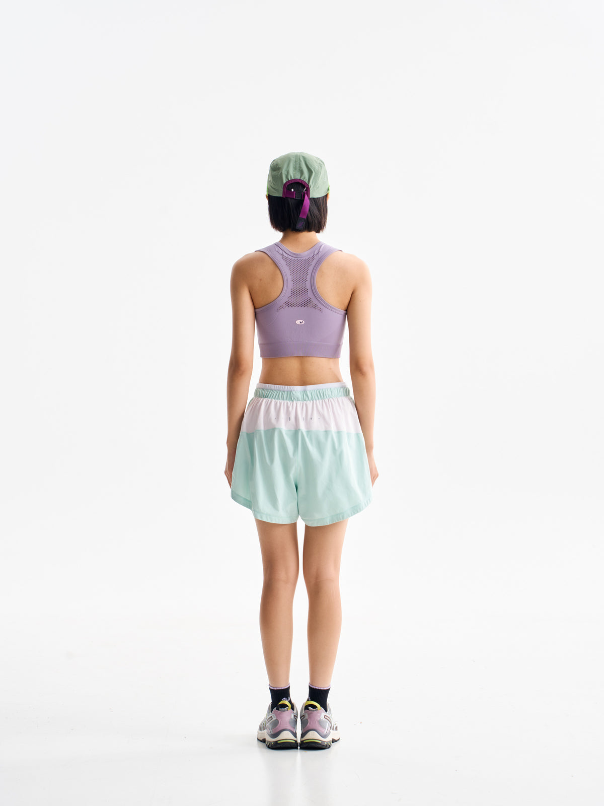 Green hiking shorts — back view showing the pale rear waistband panel