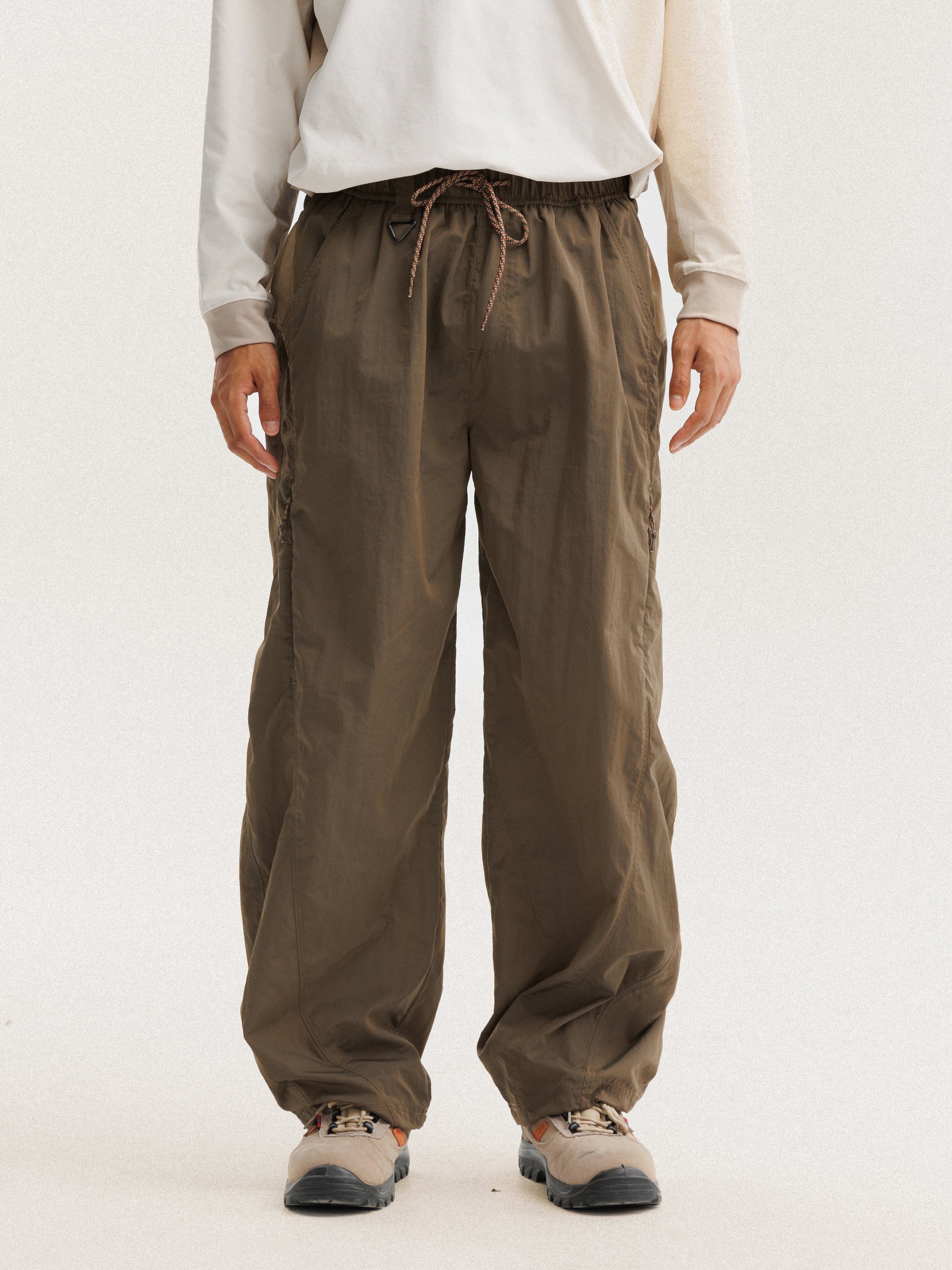 Olive Brown hiking pants — front view showing the drawcord and full leg silhouette