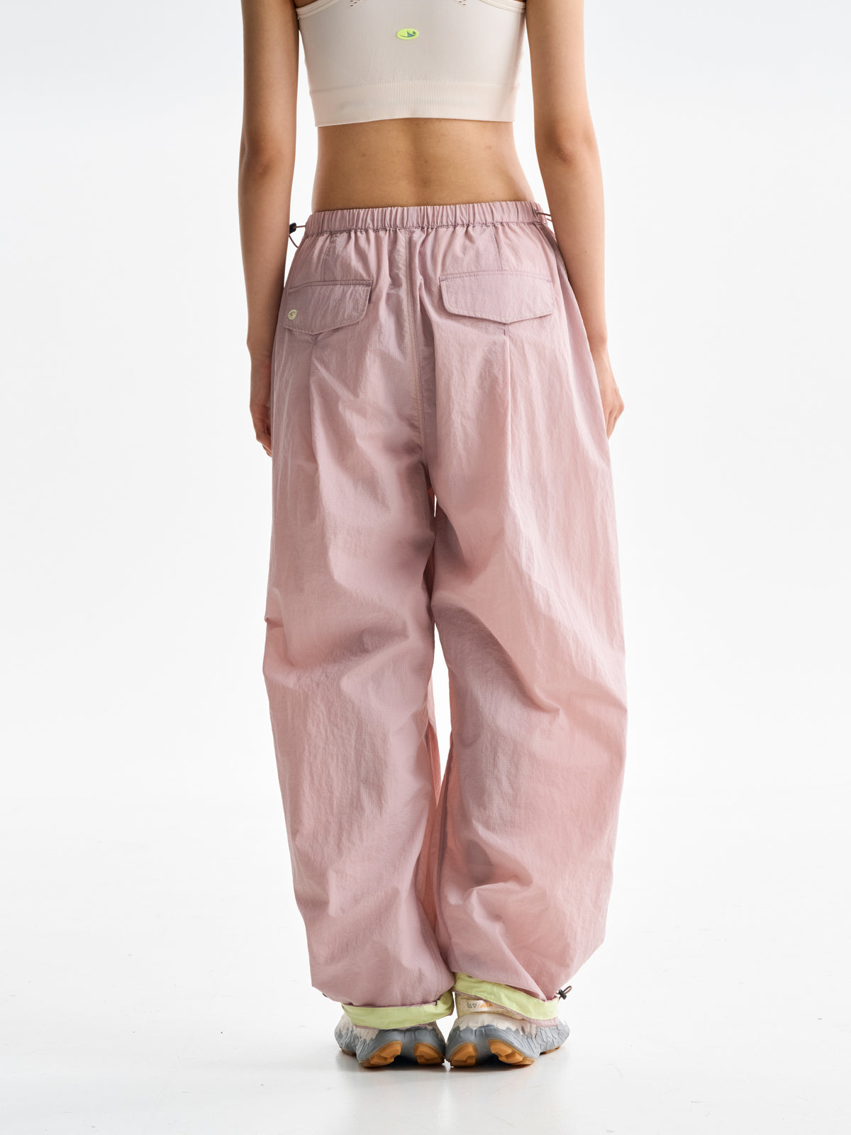 Pink hiking pants — back view showing the patch pockets and gathered hems
