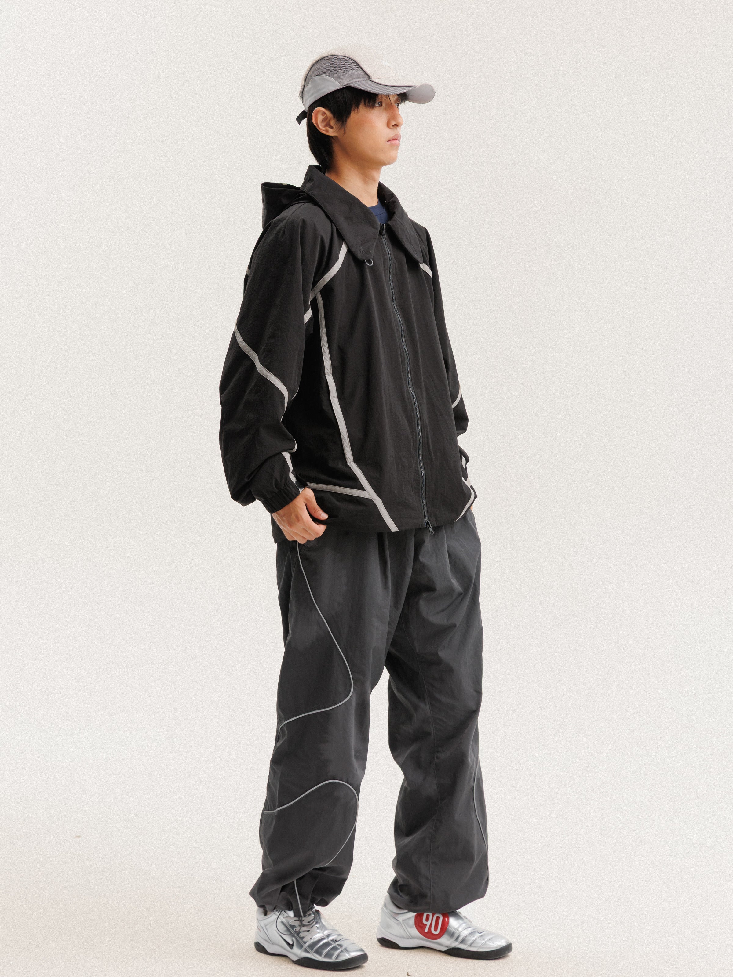 Black jacket — front three-quarter view showing the side panels and sleeve shape