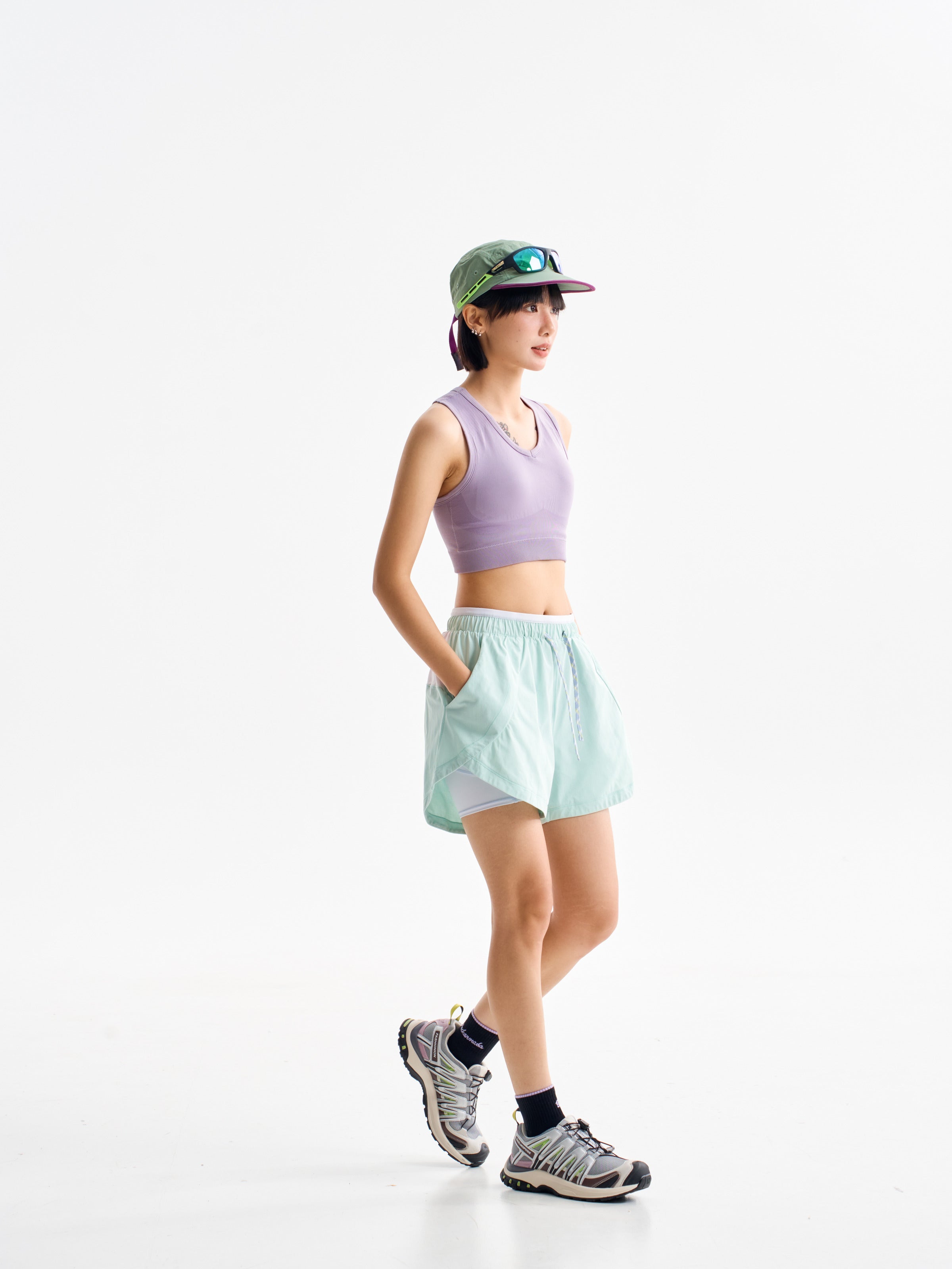 Green hiking shorts — walking side view with the inner layer visible