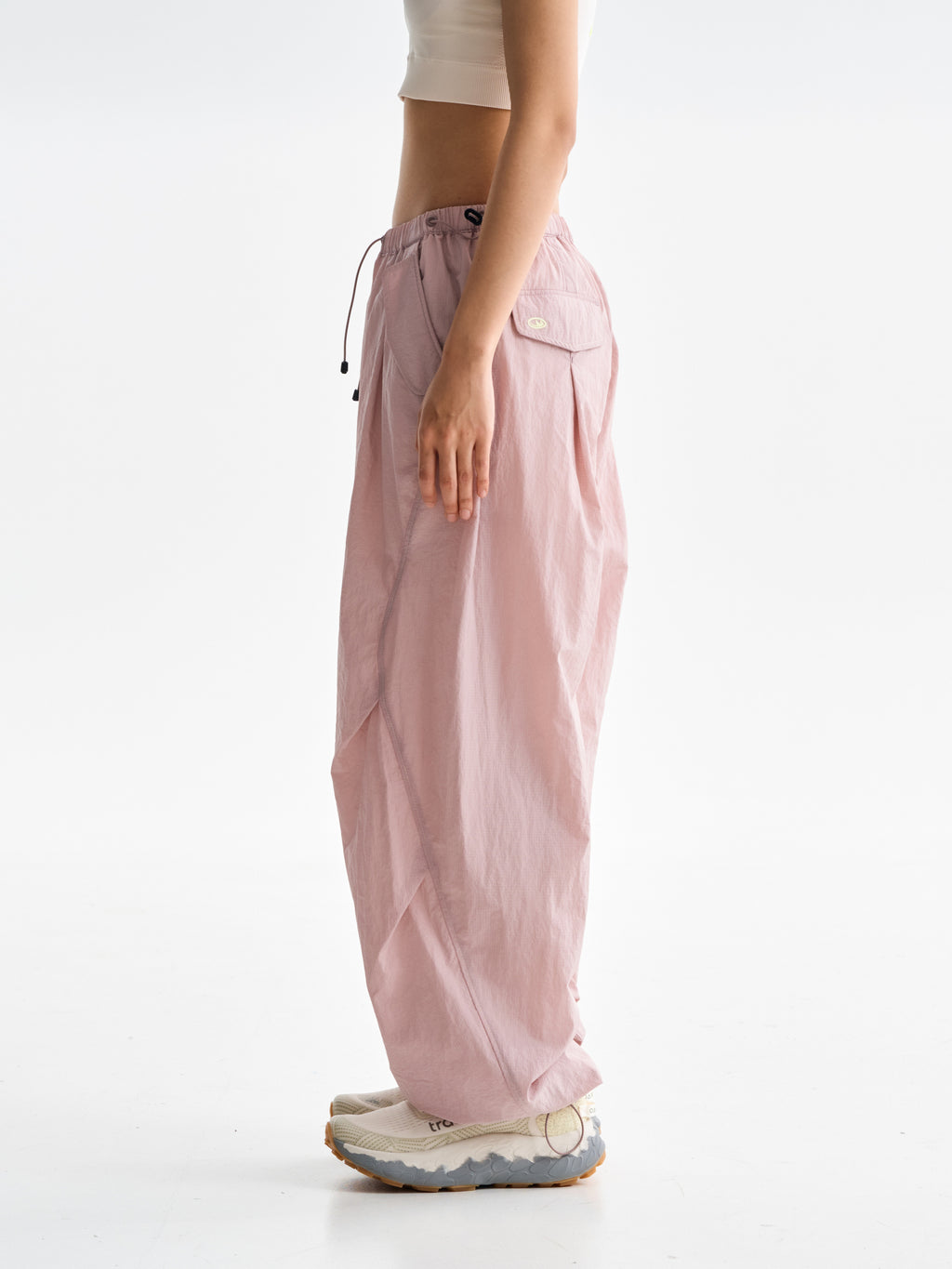 Pink hiking pants — side view showing the relaxed leg width and rear pocket