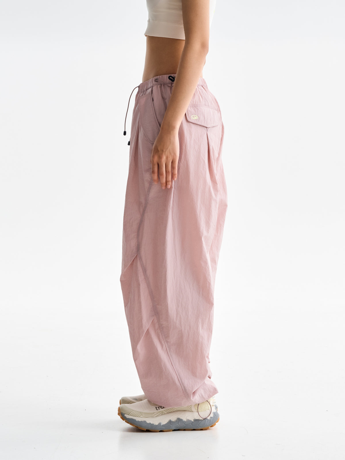 Pink hiking pants — side view showing the relaxed leg width and rear pocket