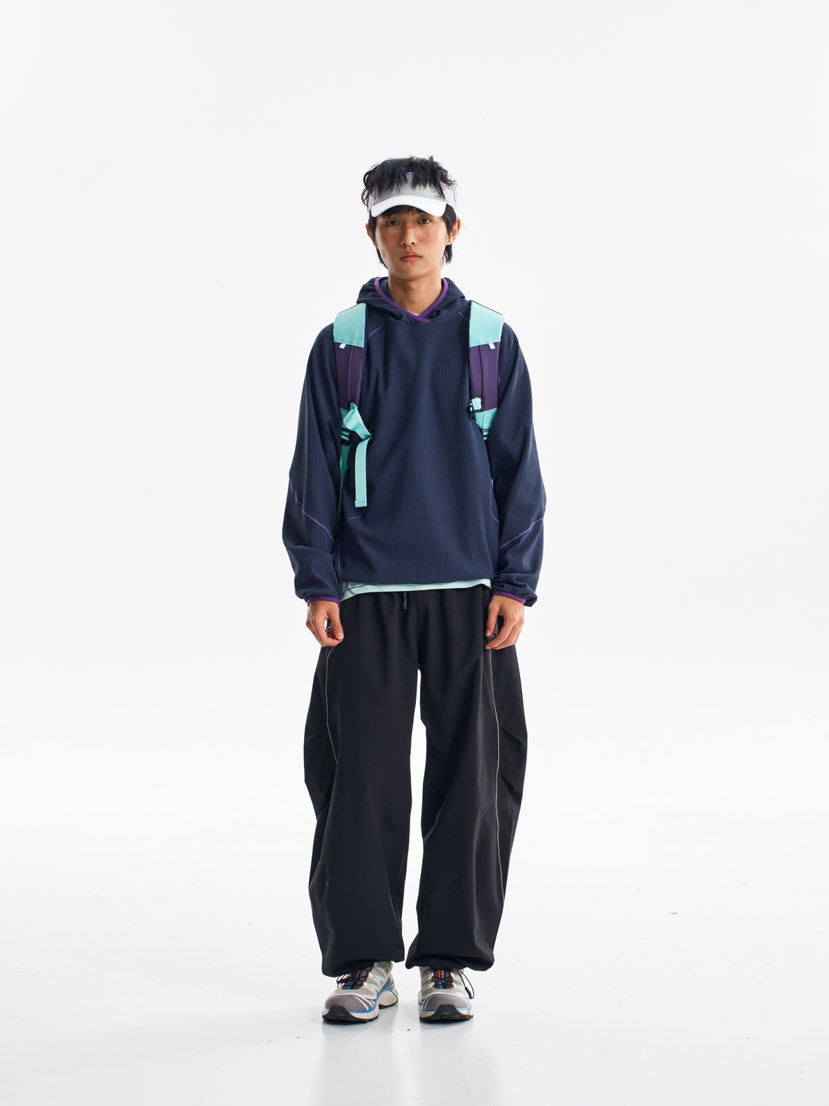 Black hiking pants — front view showing the curved legs and gathered hems