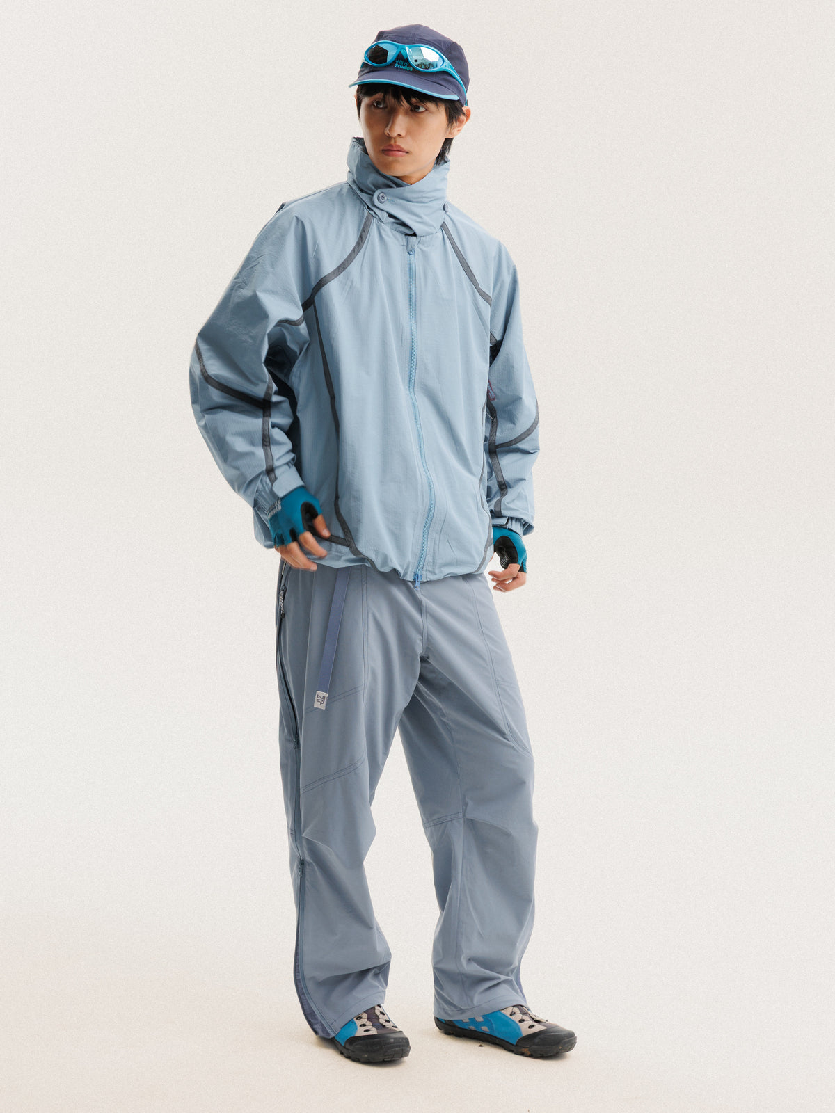 Blue jacket — front view with the zip closed and curved sleeve panels visible