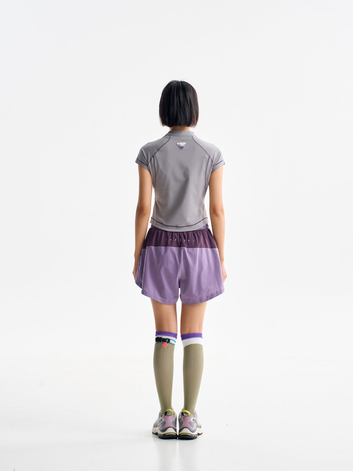 Purple hiking shorts — back view showing the contrasting rear waist panel