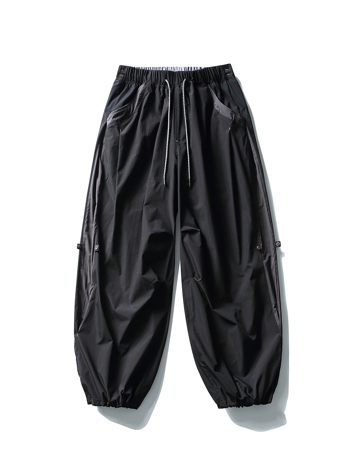 Black hiking pants — flat front view with both hems gathered