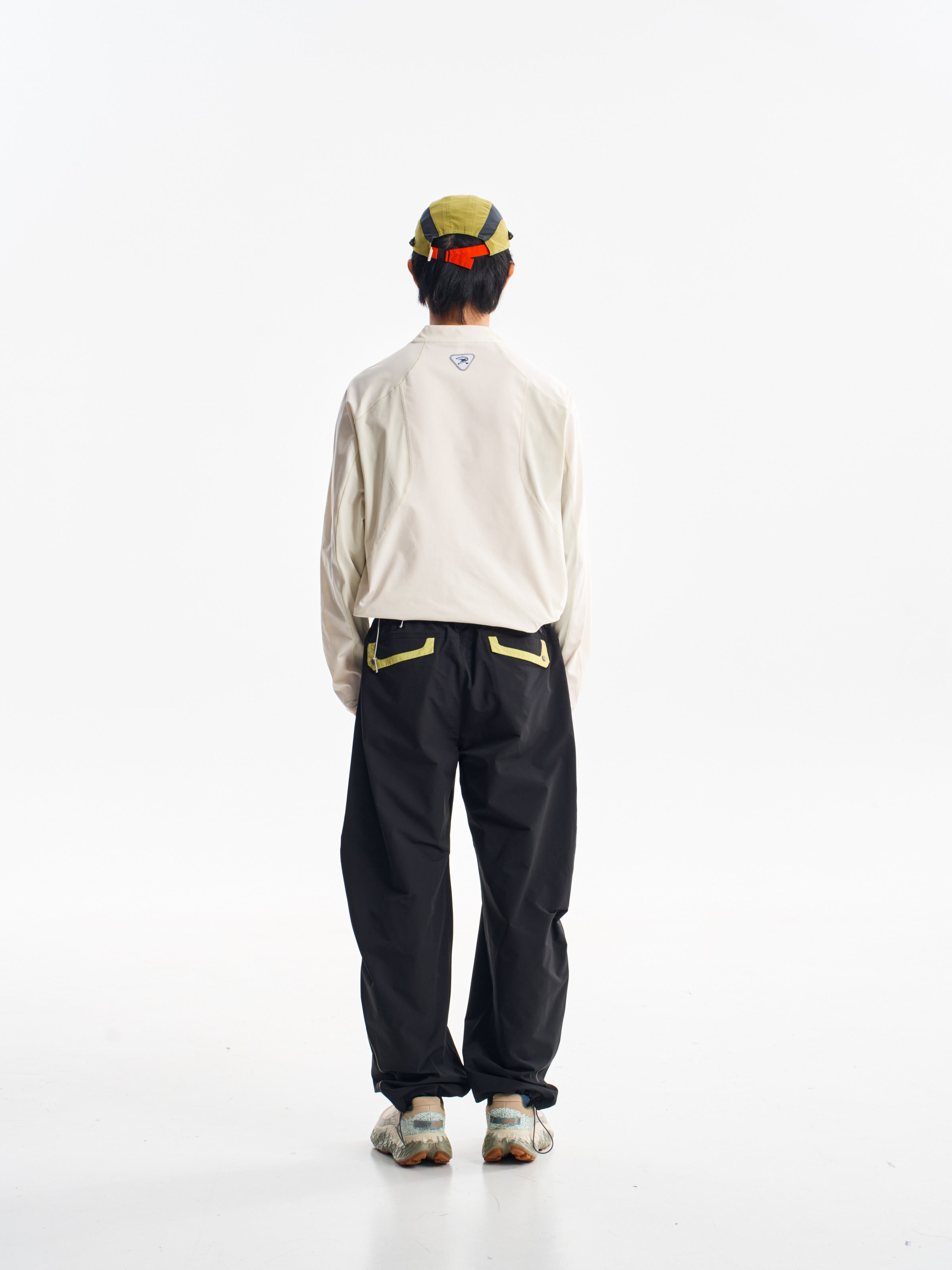 Black hiking pants — back view showing the contrast pocket trims