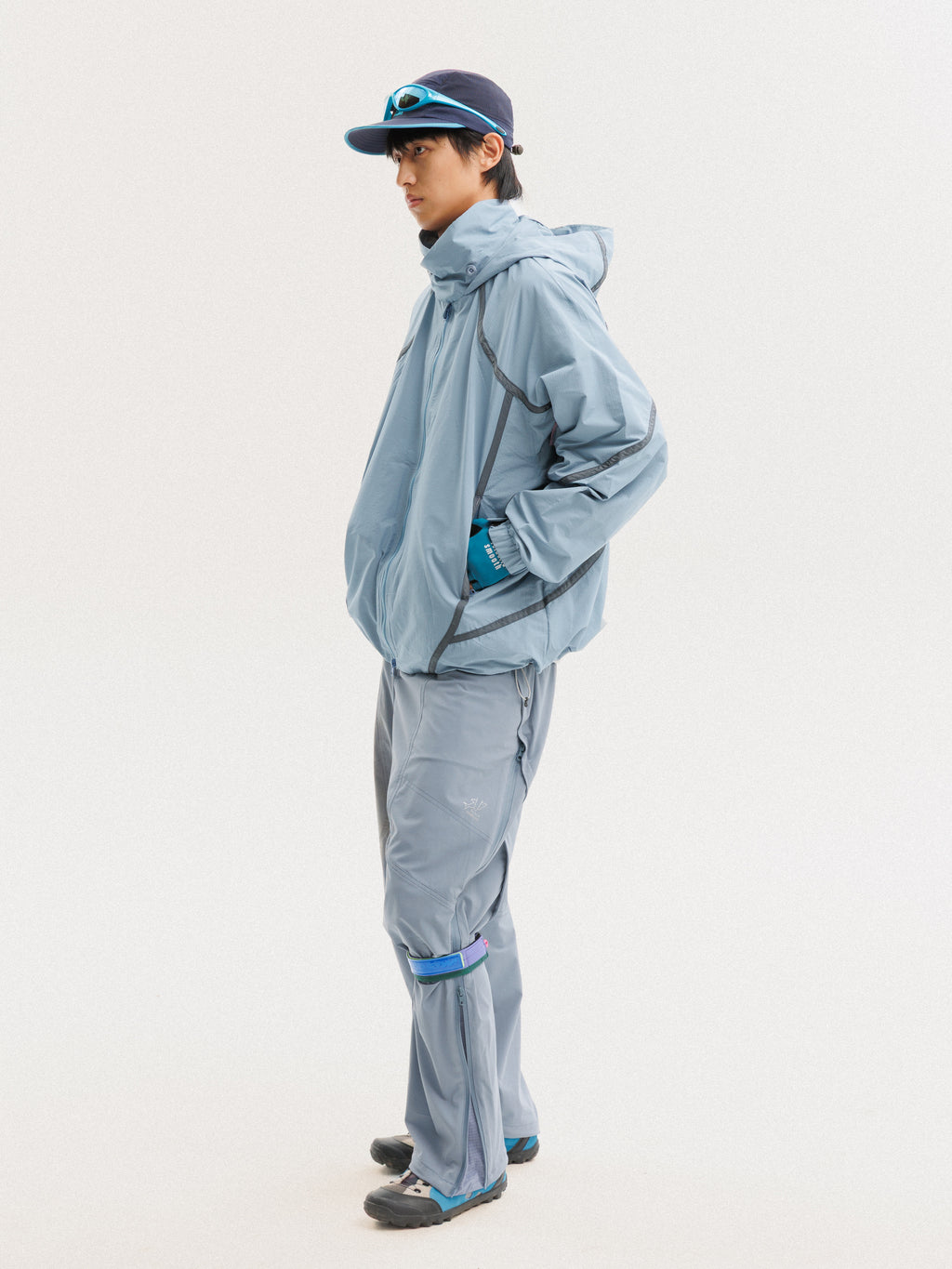 Blue jacket — side view showing the hood, sleeve panels and jacket length
