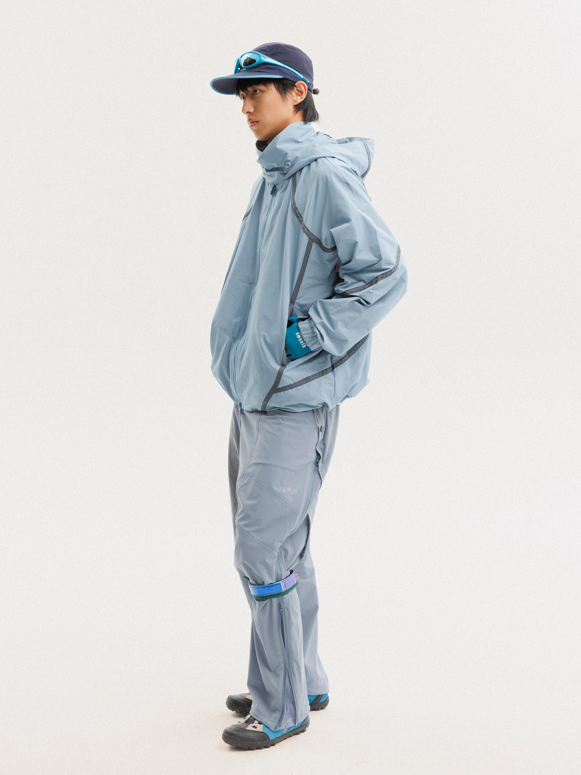 Blue jacket — side view showing the hood, sleeve panels and jacket length