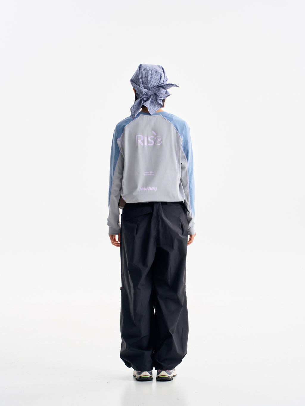 Black hiking pants — rear view showing the full leg shape below a jacket