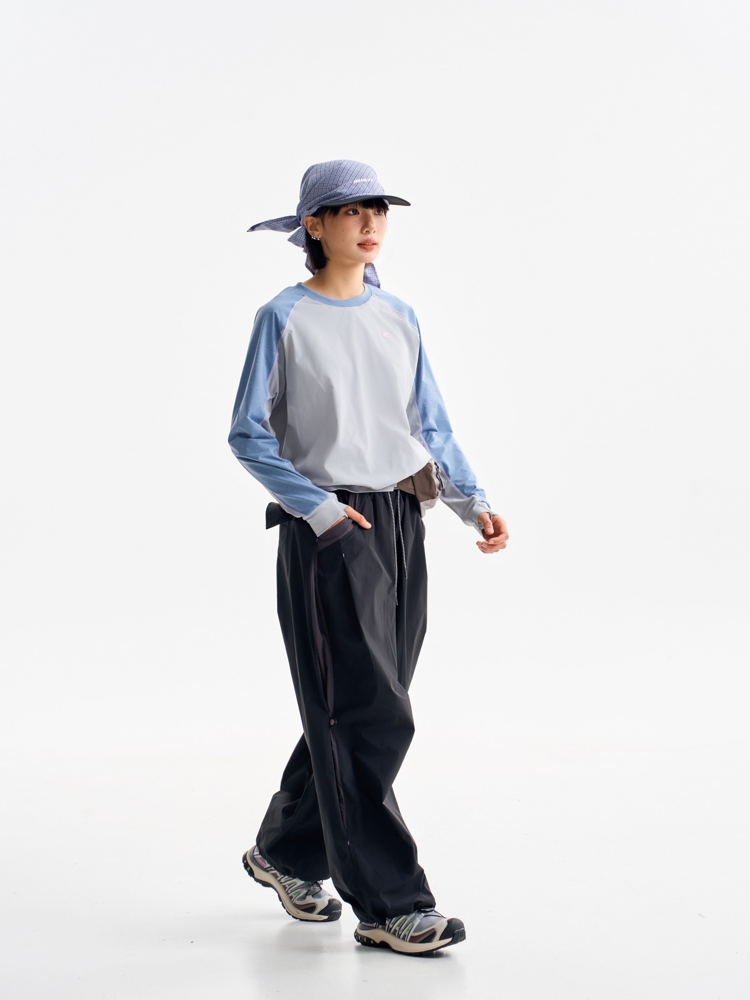 Black hiking pants — walking side view with the gathered leg silhouette