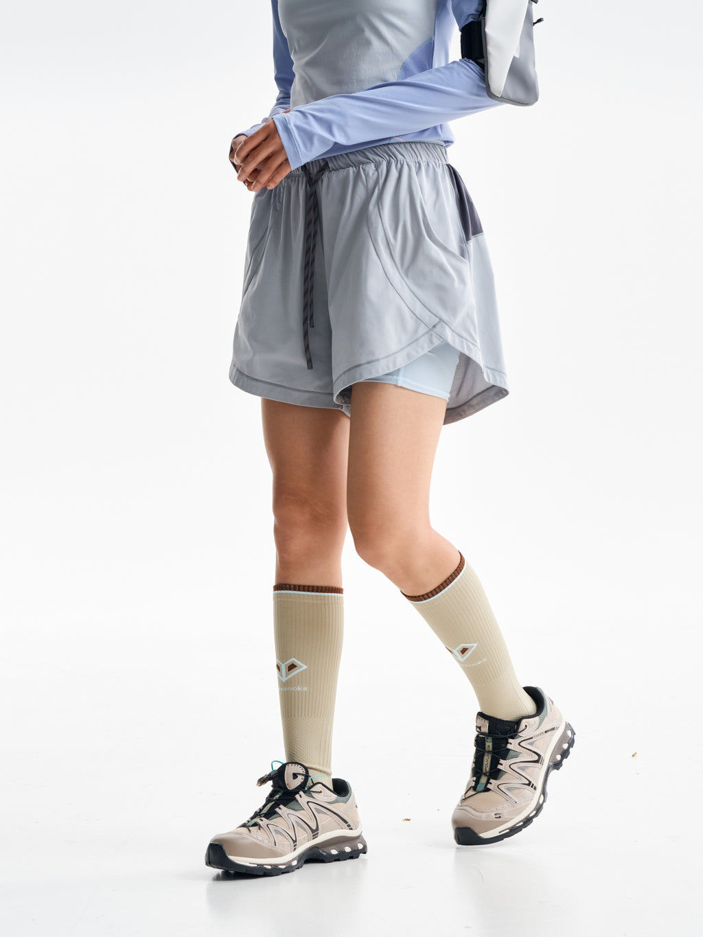 Light Gray hiking shorts — walking side view showing the curved outer layer