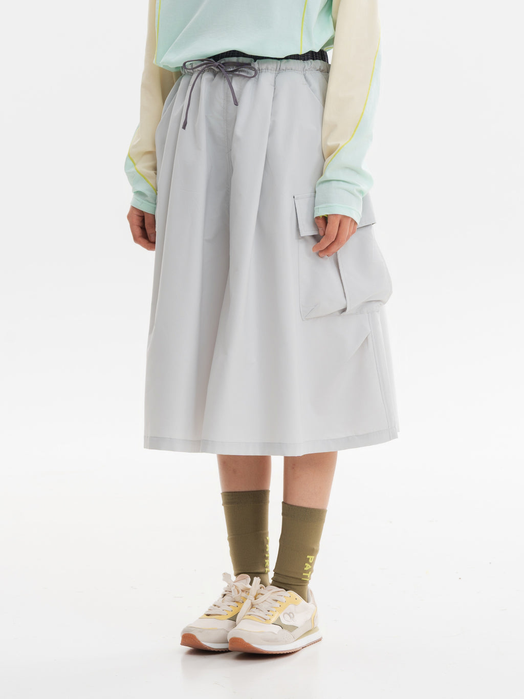 Light Gray hiking capri pants — side view showing the cargo pocket flap and pleated bag