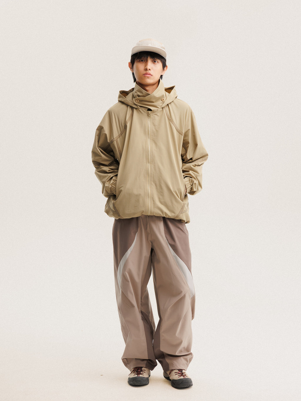 Camel jacket — front view with the zip closed and curved sleeve panels visible