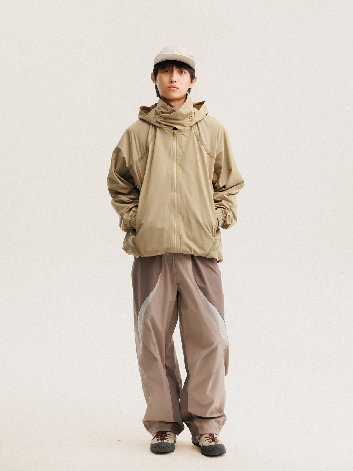 Camel jacket — front view with the zip closed and curved sleeve panels visible