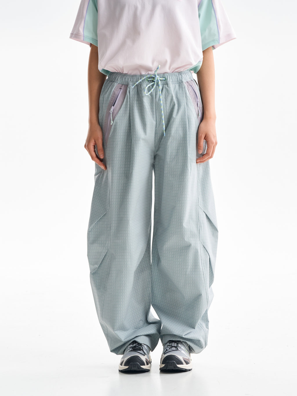 Celadon Green hiking cargo pants — front view showing the curved legs and checked fabric