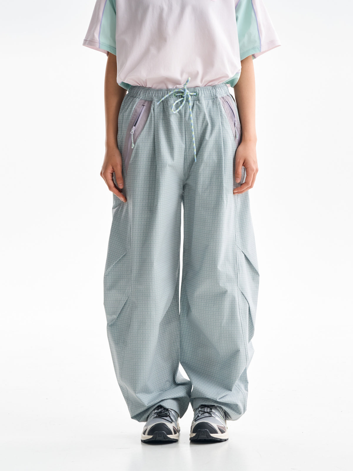 Celadon Green hiking cargo pants — front view showing the curved legs and checked fabric