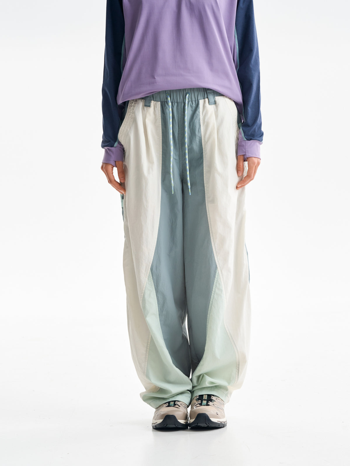 Cyan Green hiking pants — front view showing the pale side panels and drawcord waist