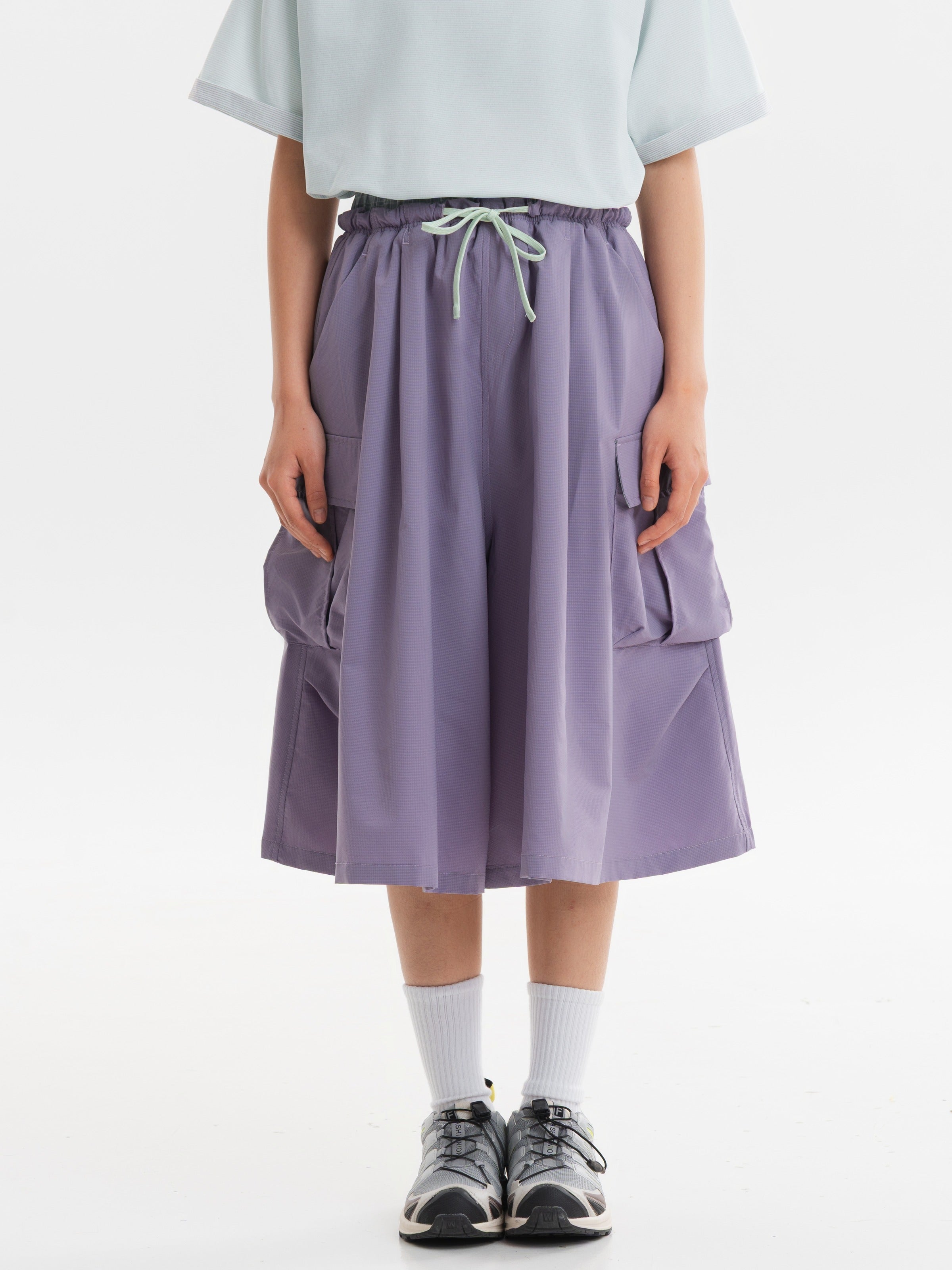 Gray Pink hiking capri pants — front view with a pale green drawcord and wide cropped legs