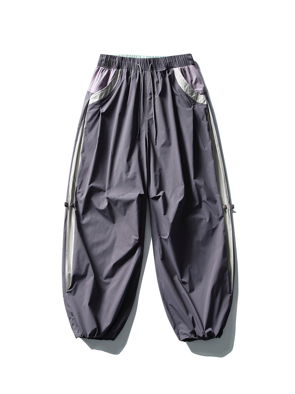 Purple hiking pants — flat front view showing pale pocket trim and gathered hems