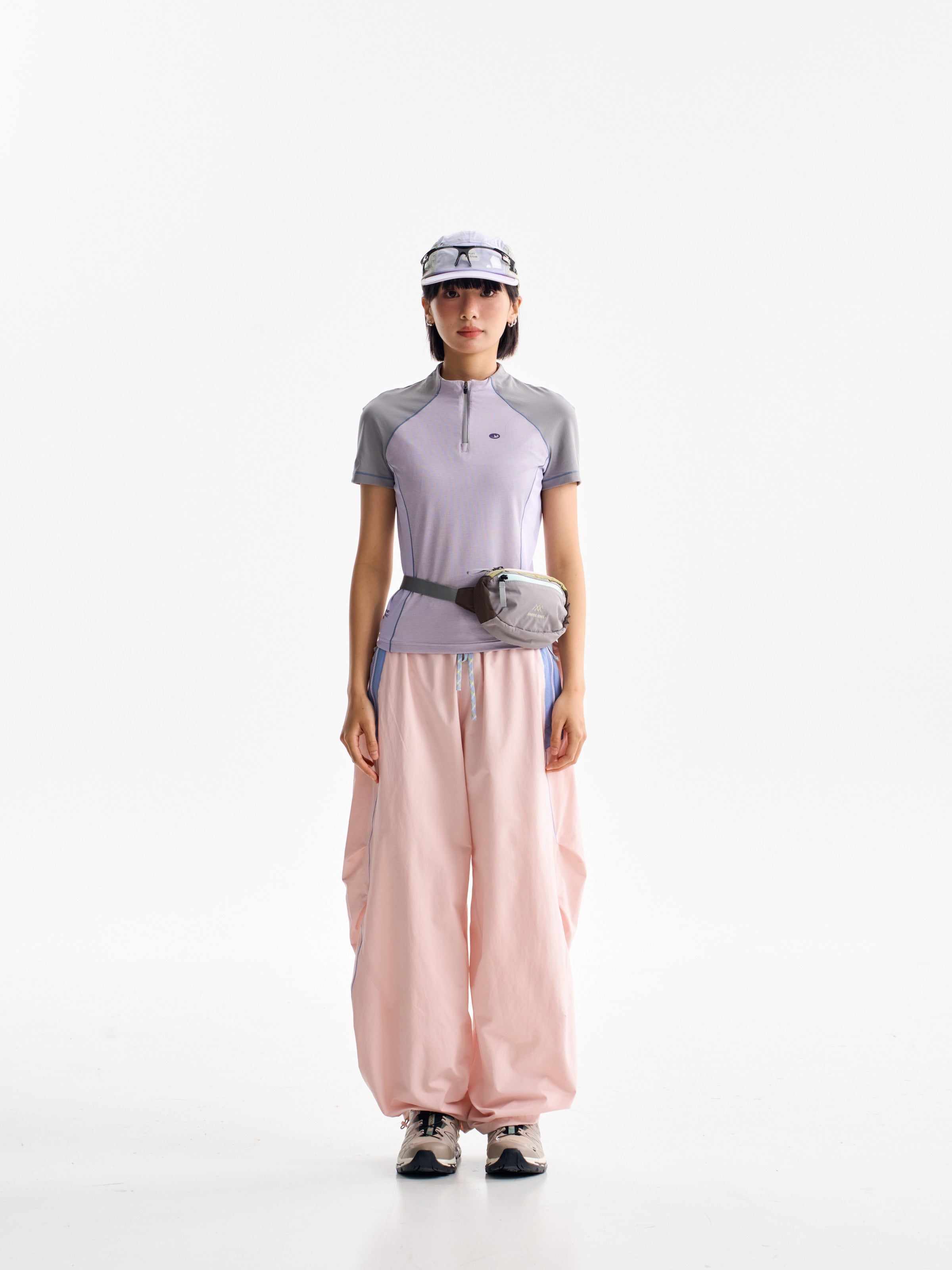 Pink hiking pants — front view showing the curved legs and gathered hems
