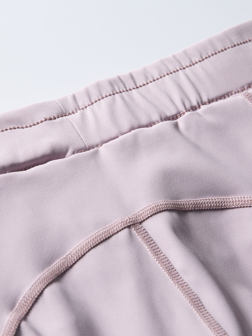Purple hiking shorts — interior lining texture and waist seam construction