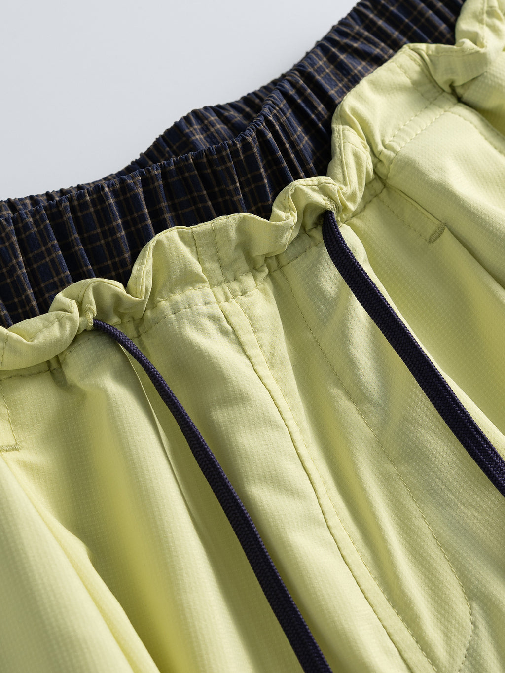 Yellow hiking capri pants — elastic waistband gathers and contrast drawcord close-up
