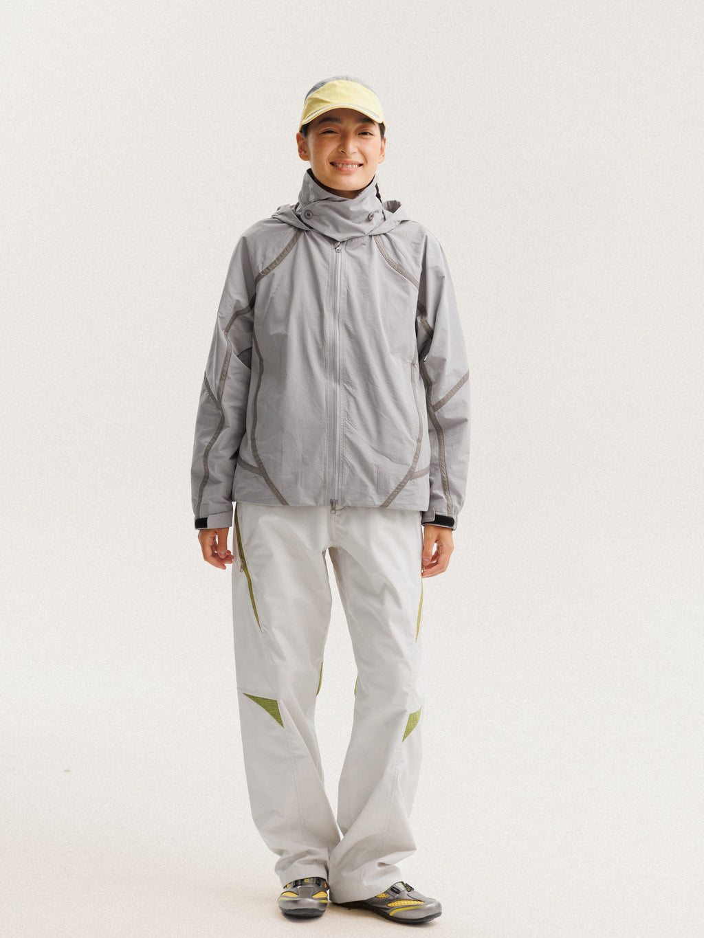 Gray jacket — front view with the zip closed and curved sleeve panels visible
