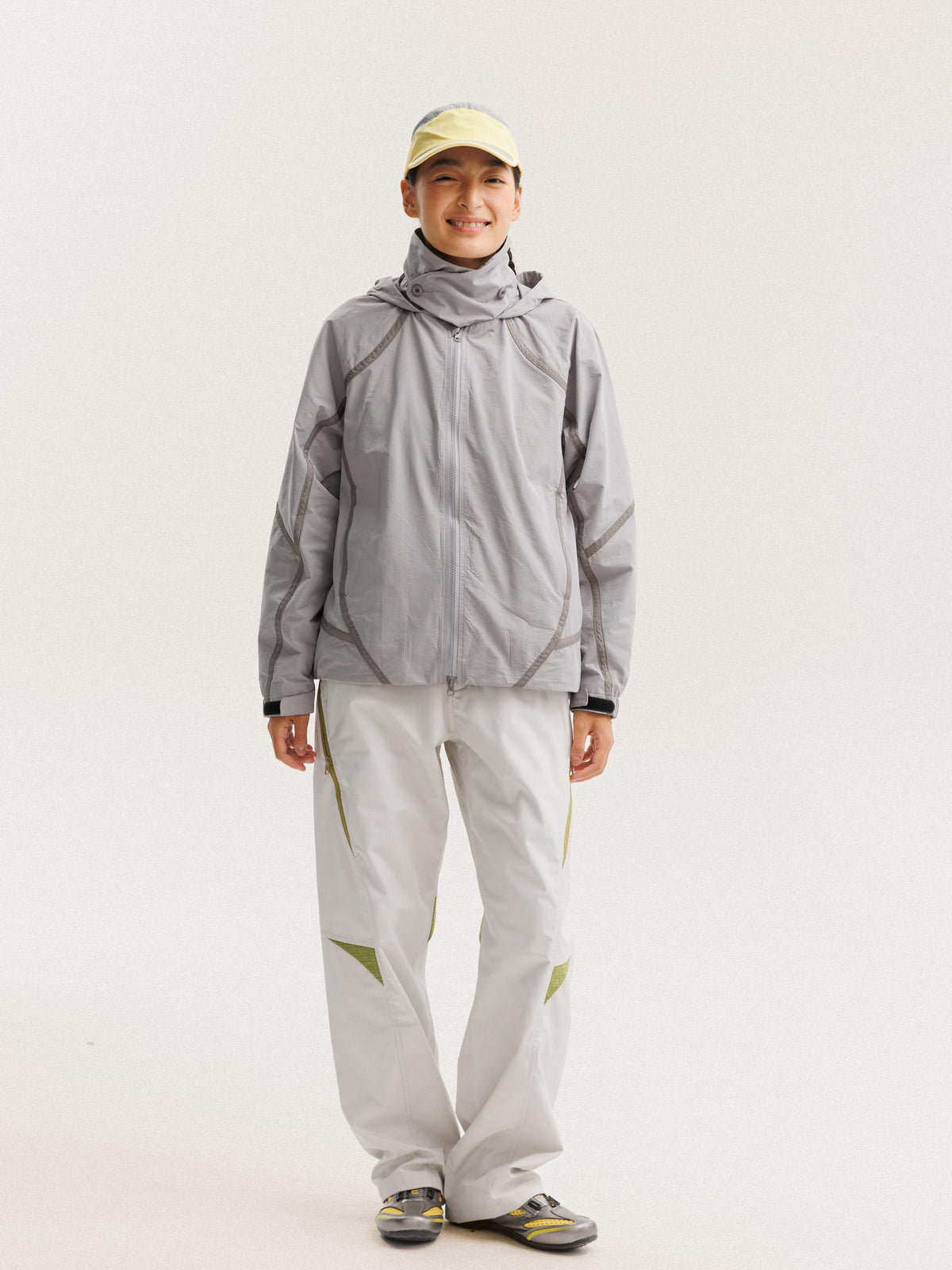 Gray jacket — front view with the zip closed and curved sleeve panels visible
