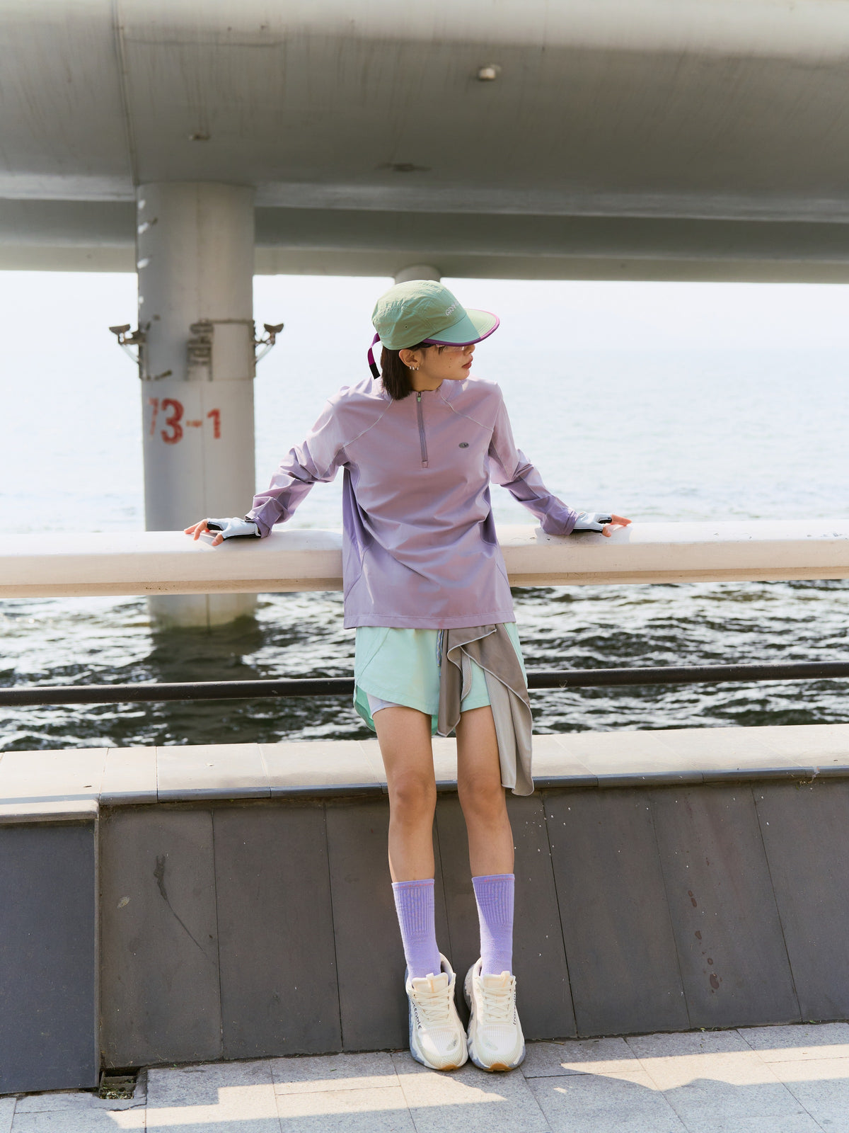 Green hiking shorts — standing by a railing with the layered legs visible