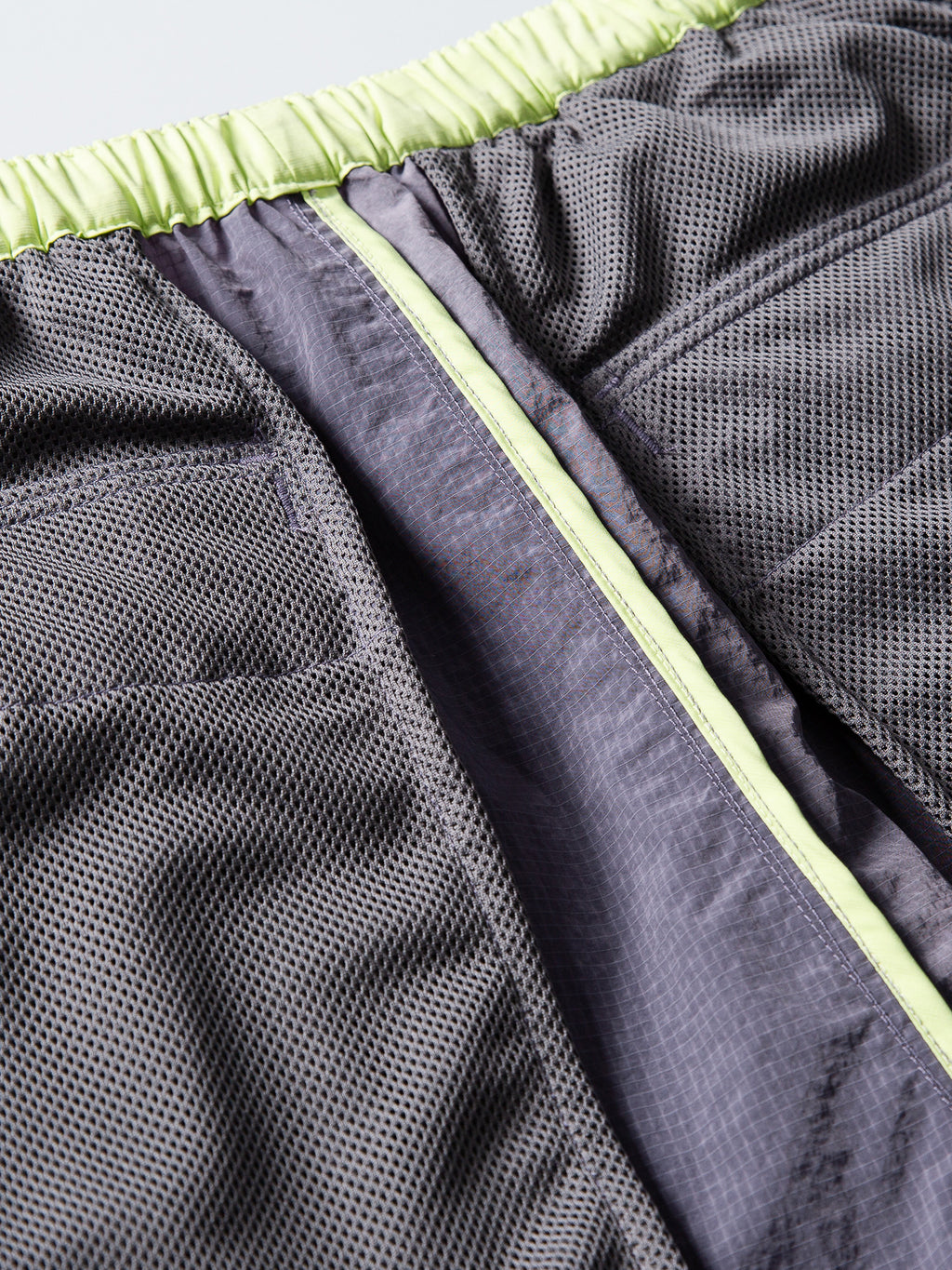 Purple hiking pants — interior mesh lining with contrasting waistband and seam binding