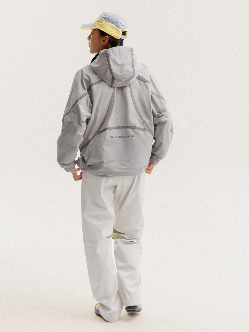 Gray jacket — rear three-quarter view showing the hood and hem