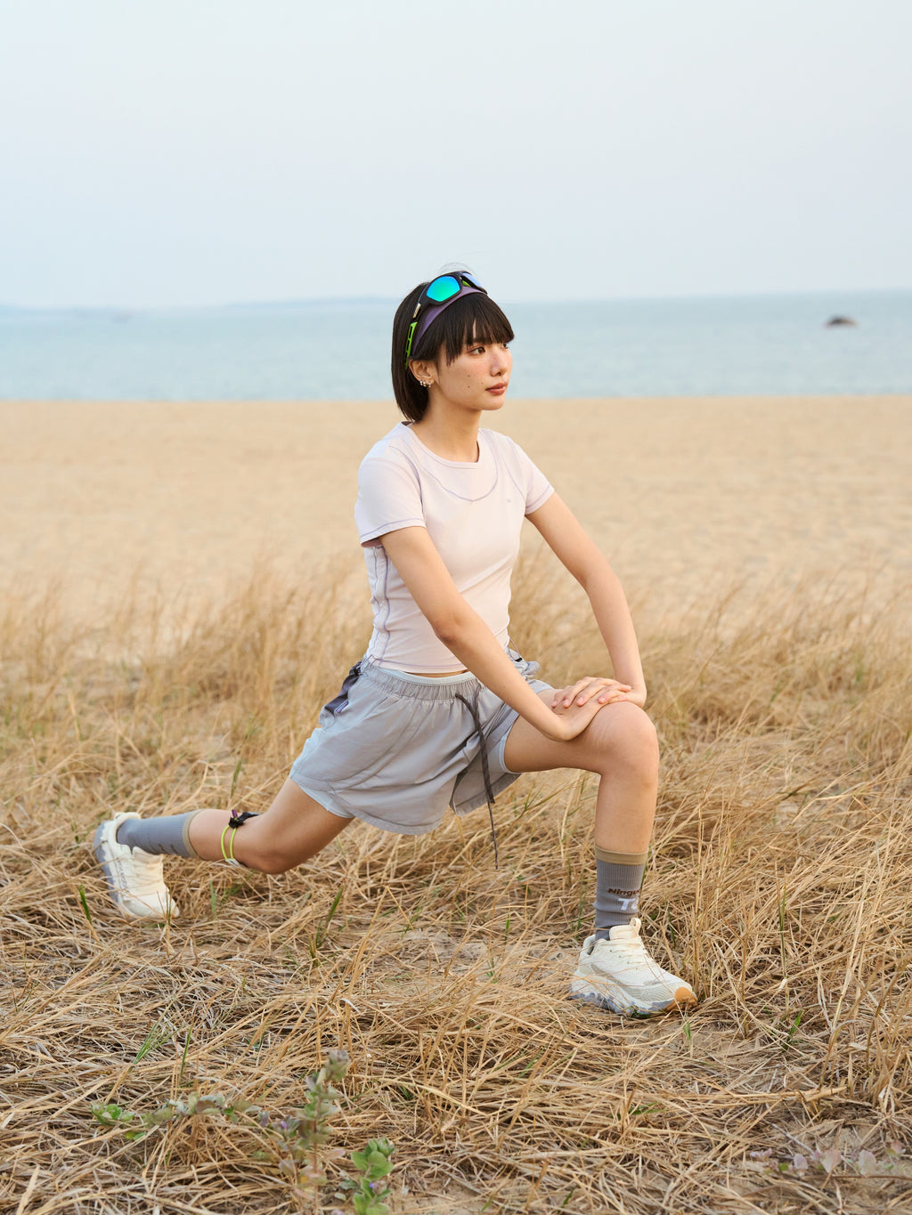Light Gray hiking shorts — outdoor lunge showing the side panels in motion