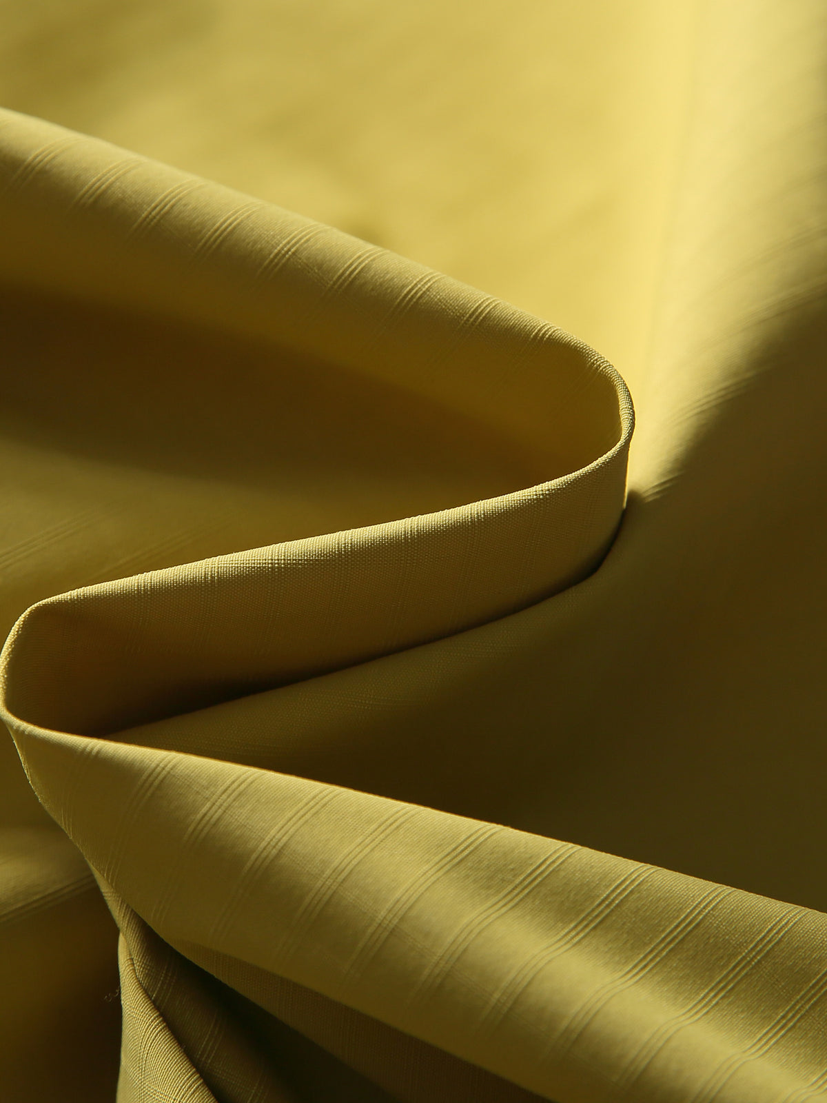 Yellow hiking pants — close-up of the woven shell texture and natural folds