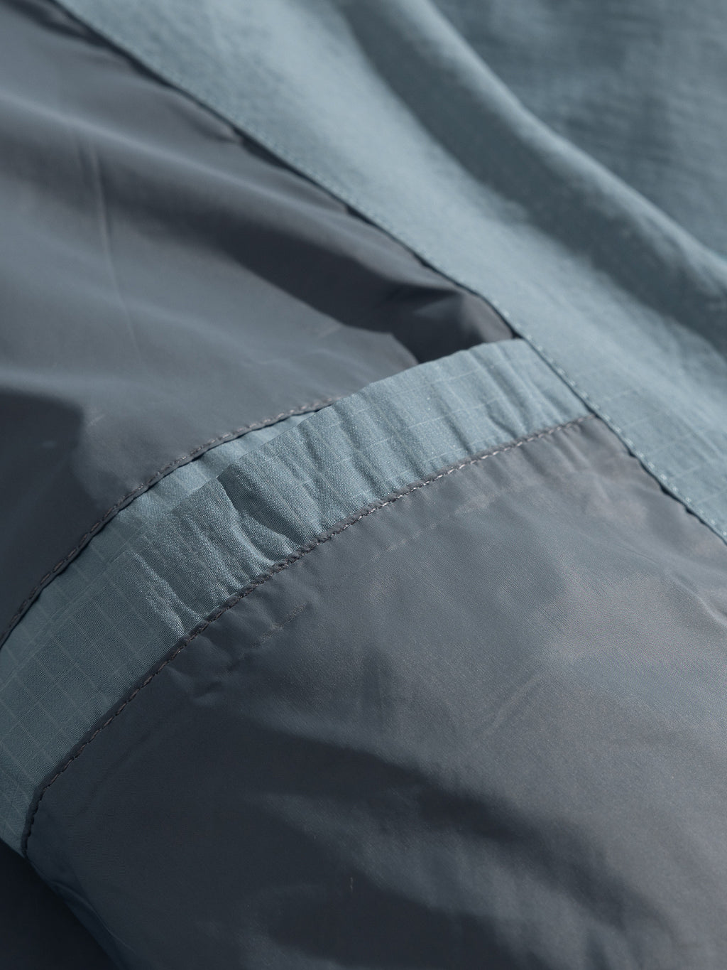 Blue jacket — interior fabric layers and bound seam close-up