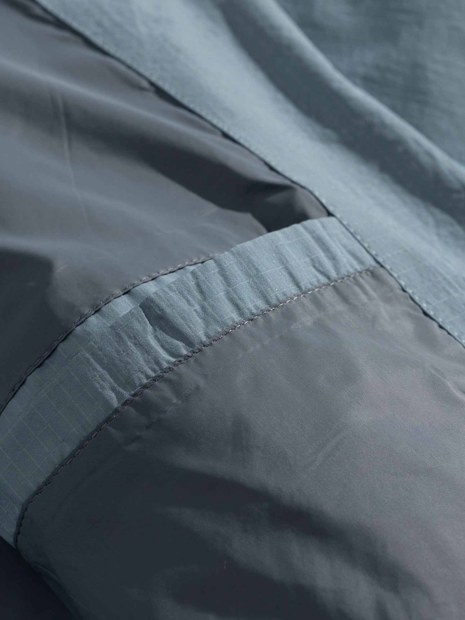 Blue jacket — interior fabric layers and bound seam close-up