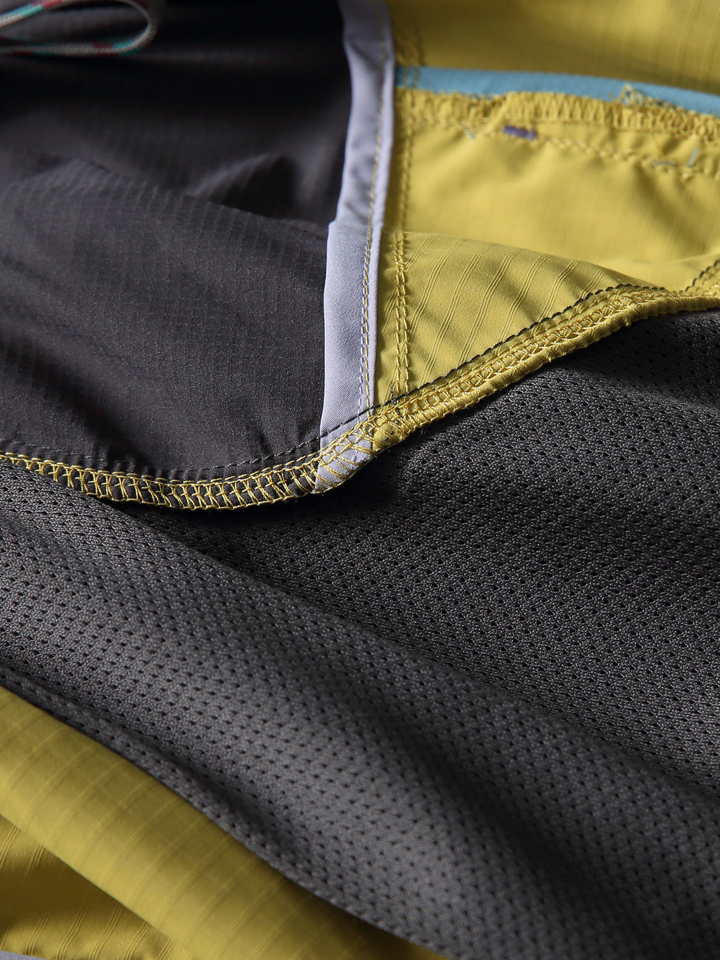 Yellow hiking pants — interior mesh lining and overlocked seam