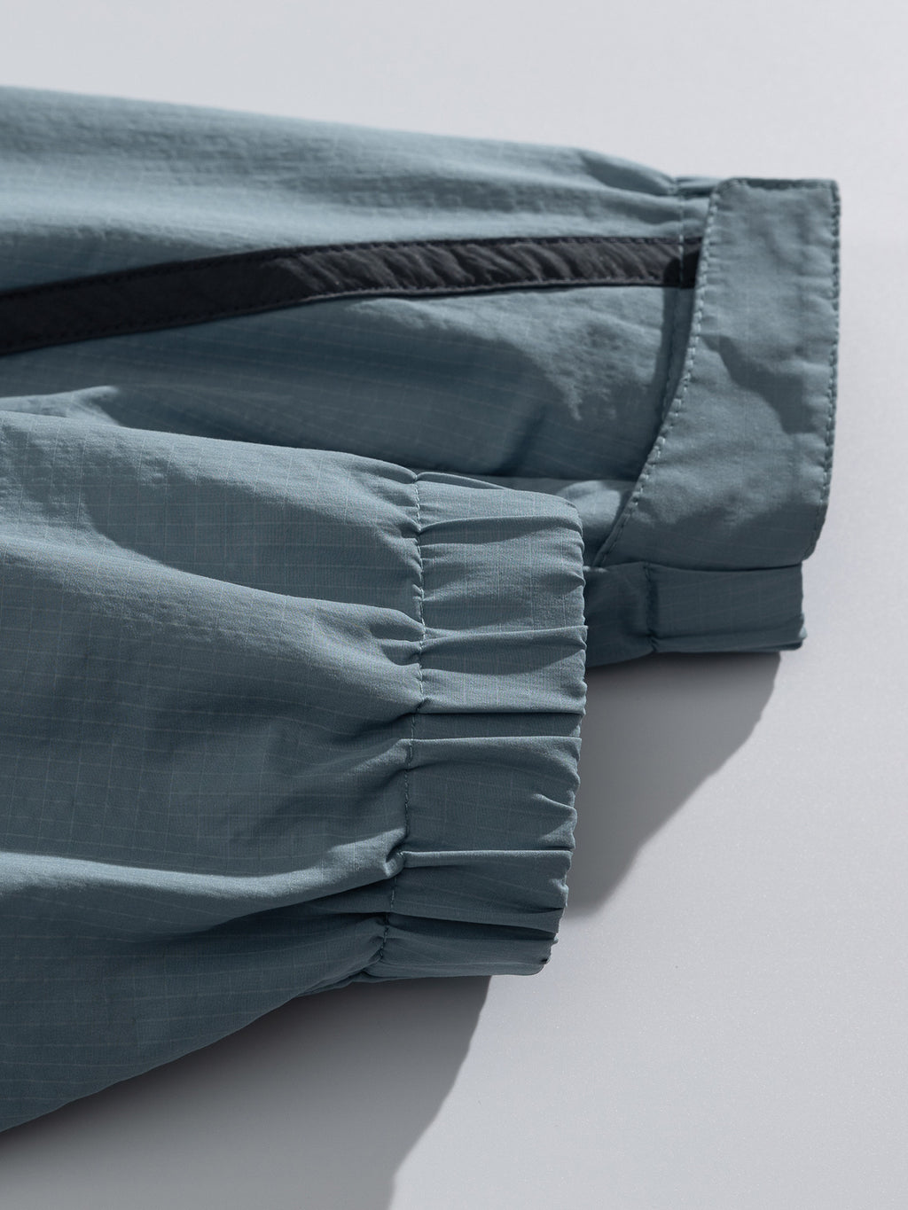 Blue jacket — elasticated cuff openings and gathered stitching